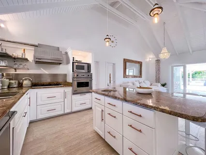 a kitchen with granite countertop white cabinets and white appliances