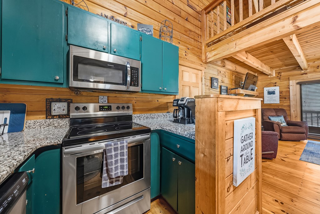 2136 Hines Gap Road Warm Springs, GA 31830 - Photo 13 of 63 a kitchen with stainless steel appliances granite countertop a stove and a microwave