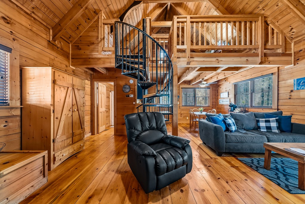 2136 Hines Gap Road Warm Springs, GA 31830 - Photo 29 of 63 a living room with furniture a wooden floor and a floor to ceiling window
