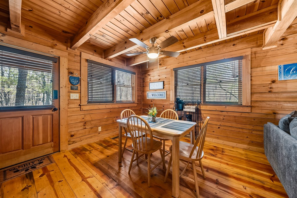 2136 Hines Gap Road Warm Springs, GA 31830 - Photo 34 of 63 a view of a patio with table and chairs with wooden floor and fence