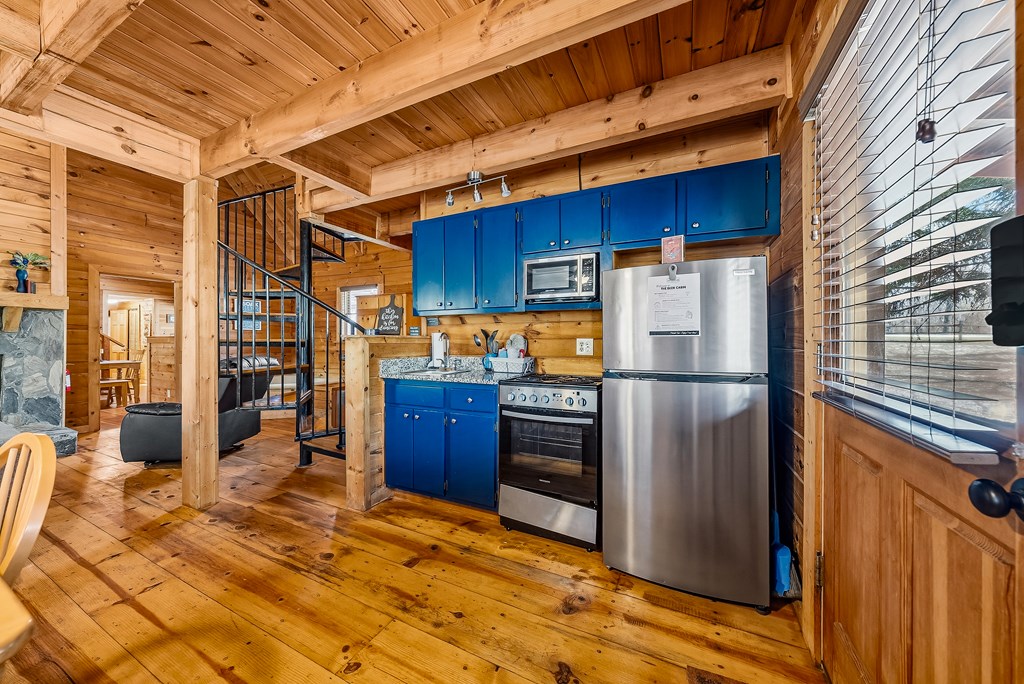 2136 Hines Gap Road Warm Springs, GA 31830 - Photo 36 of 63 a kitchen with stainless steel appliances a refrigerator and wooden cabinets