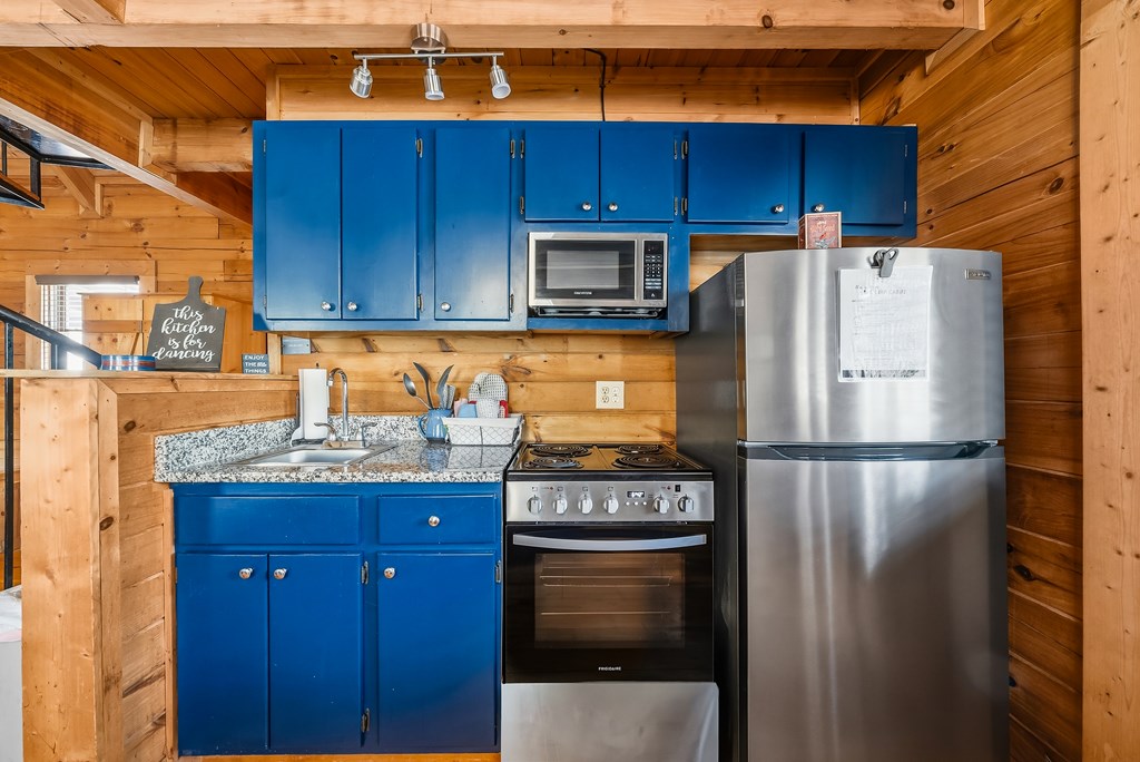 2136 Hines Gap Road Warm Springs, GA 31830 - Photo 37 of 63 a kitchen with stainless steel appliances granite countertop a refrigerator a stove and a sink with wooden cabinets