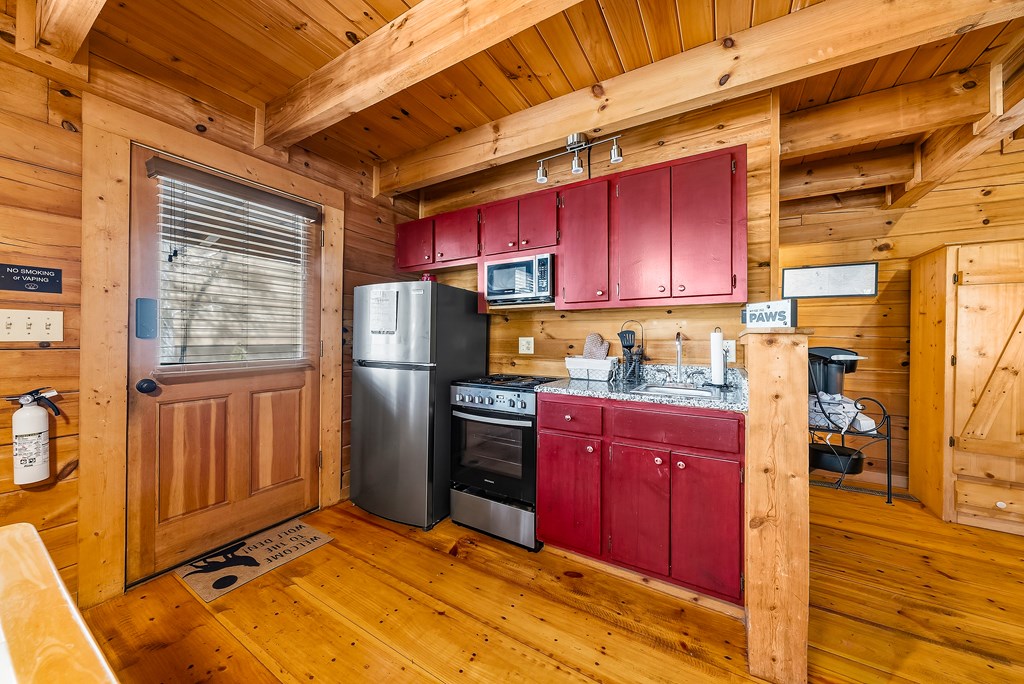 2136 Hines Gap Road Warm Springs, GA 31830 - Photo 46 of 63 a kitchen with stainless steel appliances granite countertop a refrigerator and wooden cabinets
