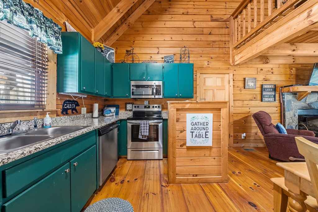 2136 Hines Gap Road Warm Springs, GA 31830 - Photo 10 of 63 a kitchen with stainless steel appliances wooden floors and wooden cabinets