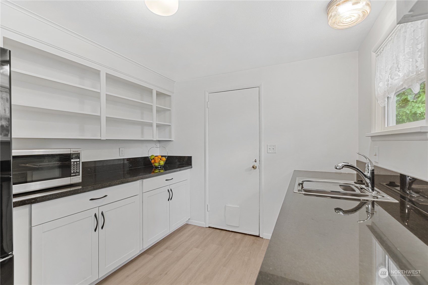 6215 Rockefeller Avenue Everett, WA 98203 - Photo 13 of 36 a kitchen with a sink and cabinets