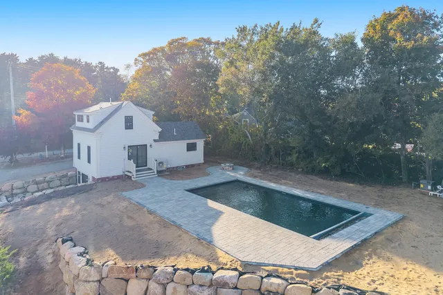 a backyard of a house with large trees