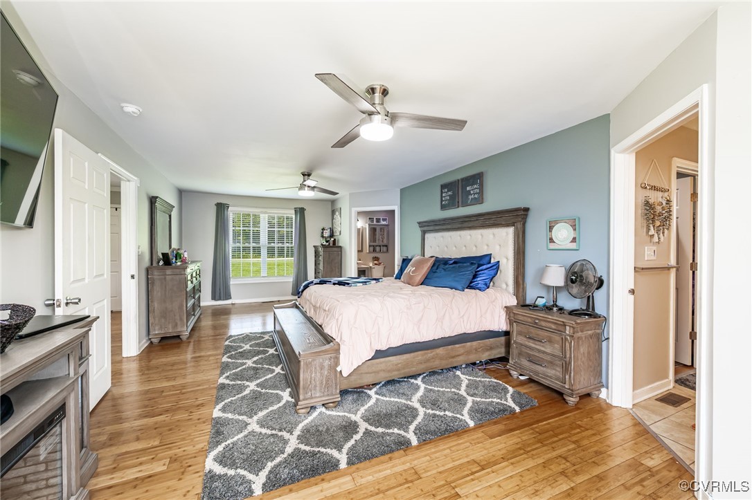 28312 Butler Branch Road Petersburg, VA 23805 - Photo 11 of 33 a bedroom with a bed and wooden floor