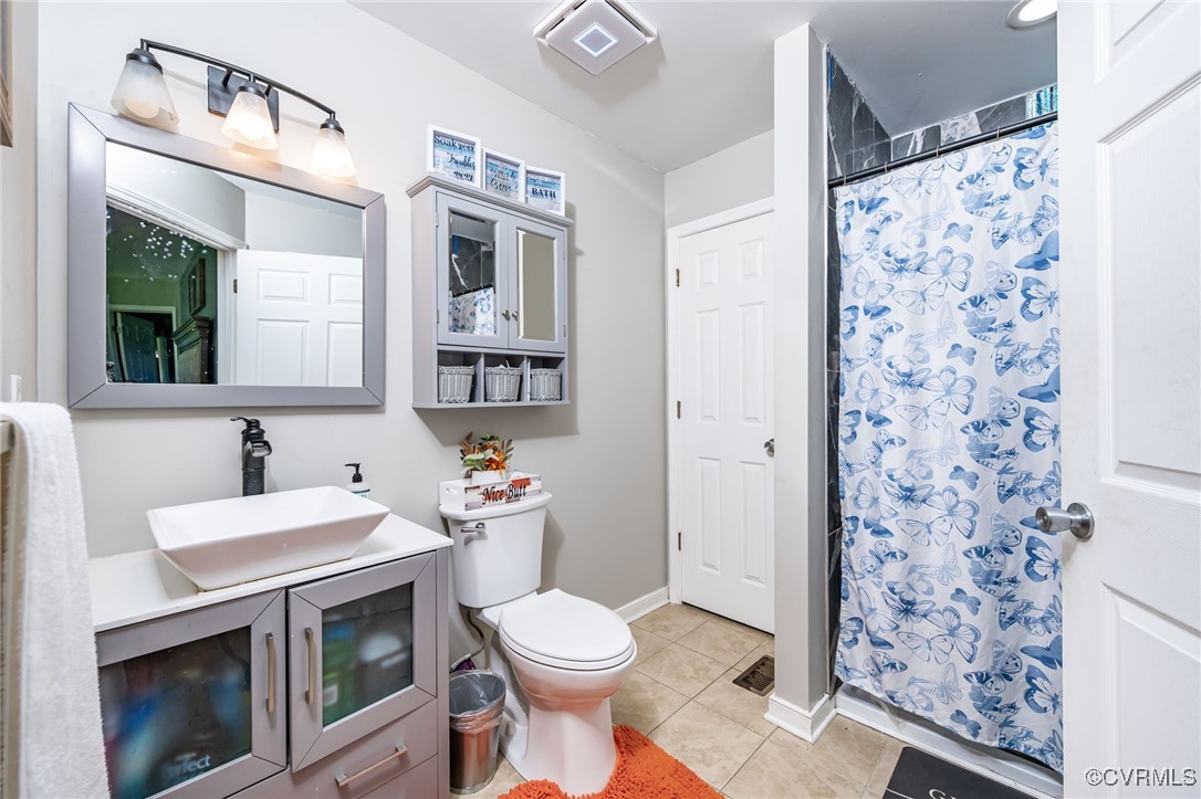 28312 Butler Branch Road Petersburg, VA 23805 - Photo 14 of 33 a bathroom with a sink toilet and shower