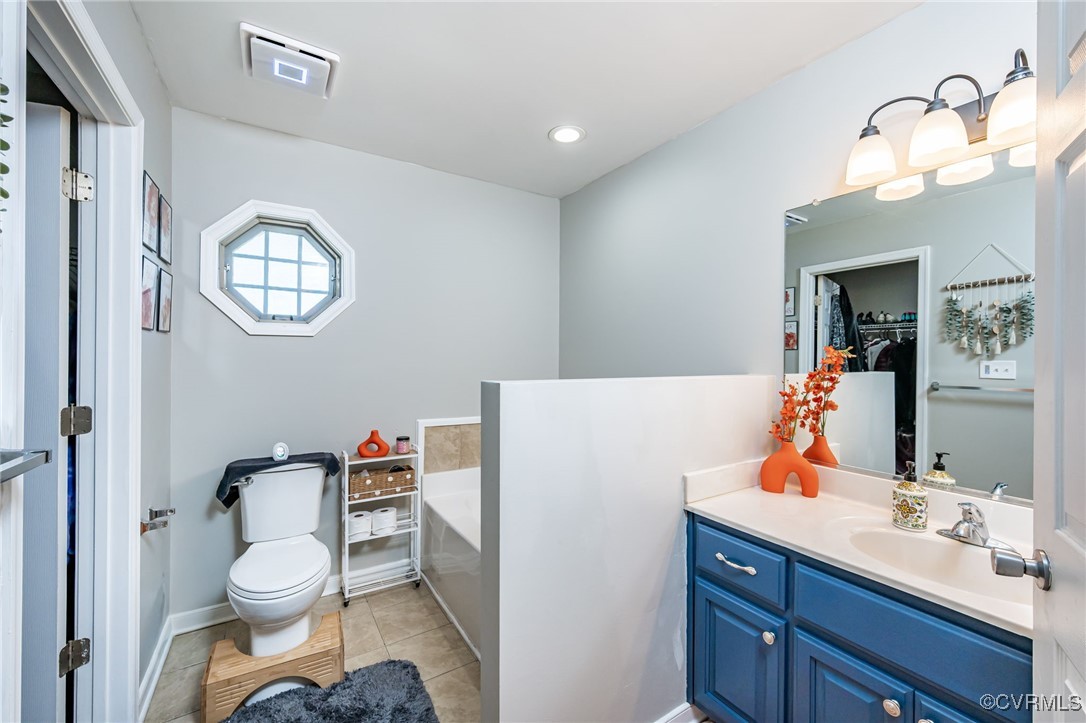 28312 Butler Branch Road Petersburg, VA 23805 - Photo 15 of 33 a bathroom with a toilet a sink and a mirror