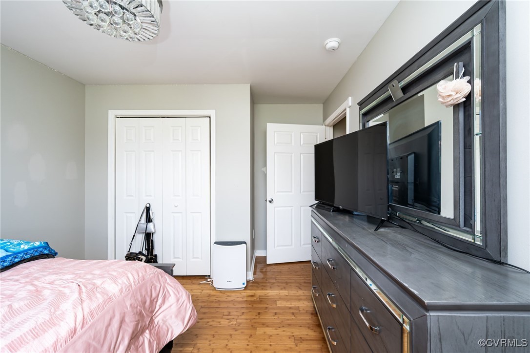 28312 Butler Branch Road Petersburg, VA 23805 - Photo 16 of 33 a bedroom with a bed and a flat tv screen on wall