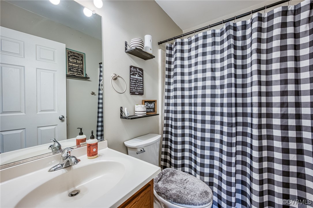 28312 Butler Branch Road Petersburg, VA 23805 - Photo 19 of 33 a bathroom with a sink toilet and a mirror