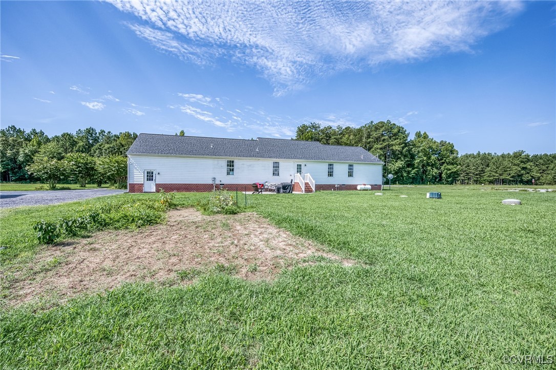 28312 Butler Branch Road Petersburg, VA 23805 - Photo 27 of 33 a backyard of a house with plants and large trees