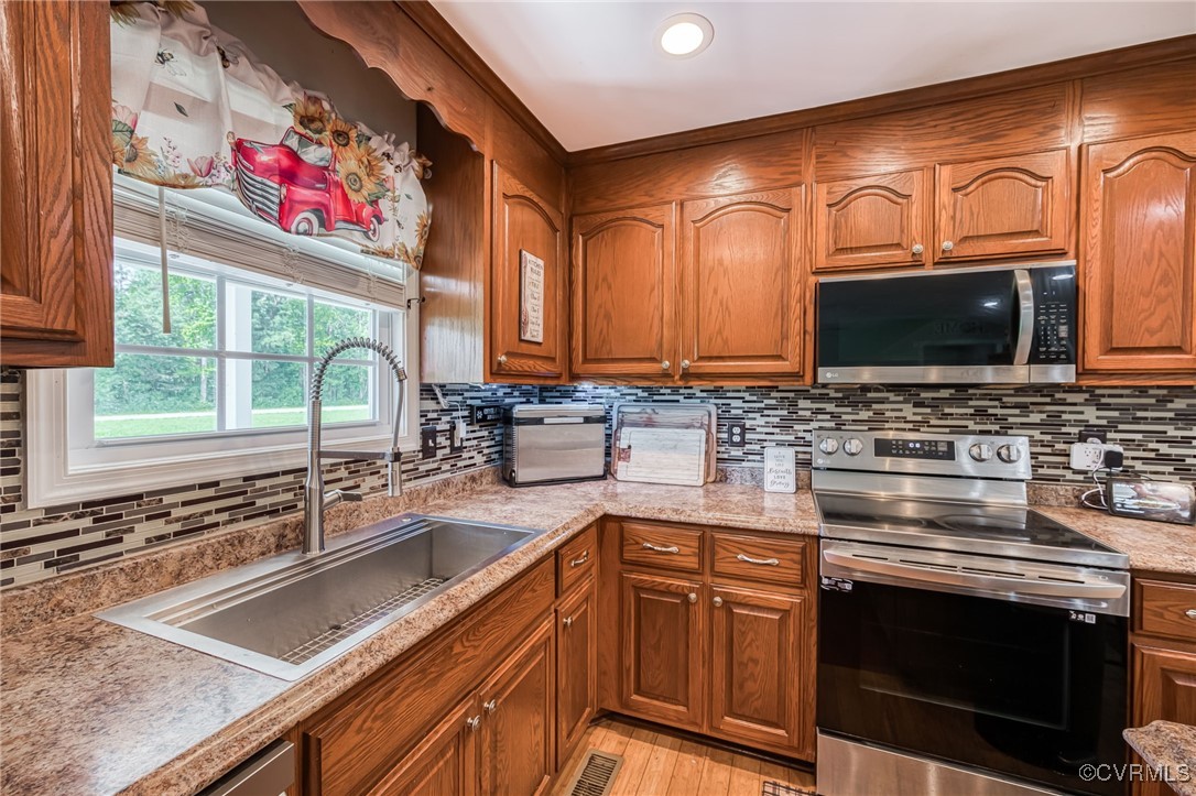 28312 Butler Branch Road Petersburg, VA 23805 - Photo 8 of 33 a kitchen with stainless steel appliances granite countertop a sink stove and microwave