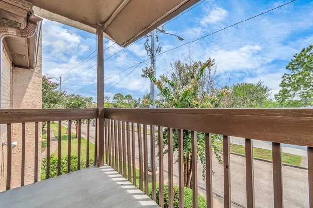 a view of a balcony with a flower plants