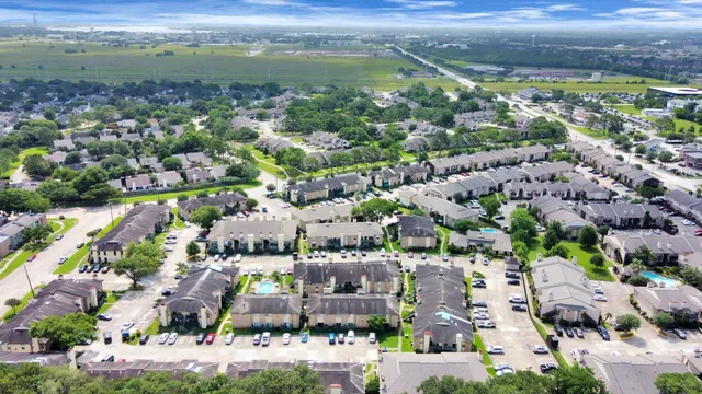an aerial view of residential houses with outdoor space