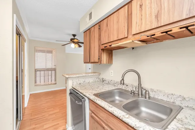 a sink with granite countertop a sink and cabinets