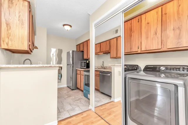 a kitchen with a sink a refrigerator and cabinets