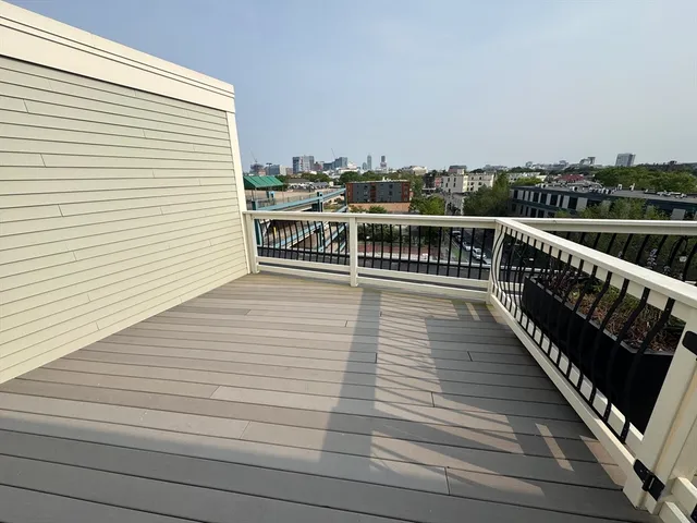 a view of a balcony with wooden floor