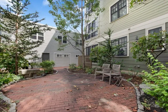 a view of a house with a yard and sitting area