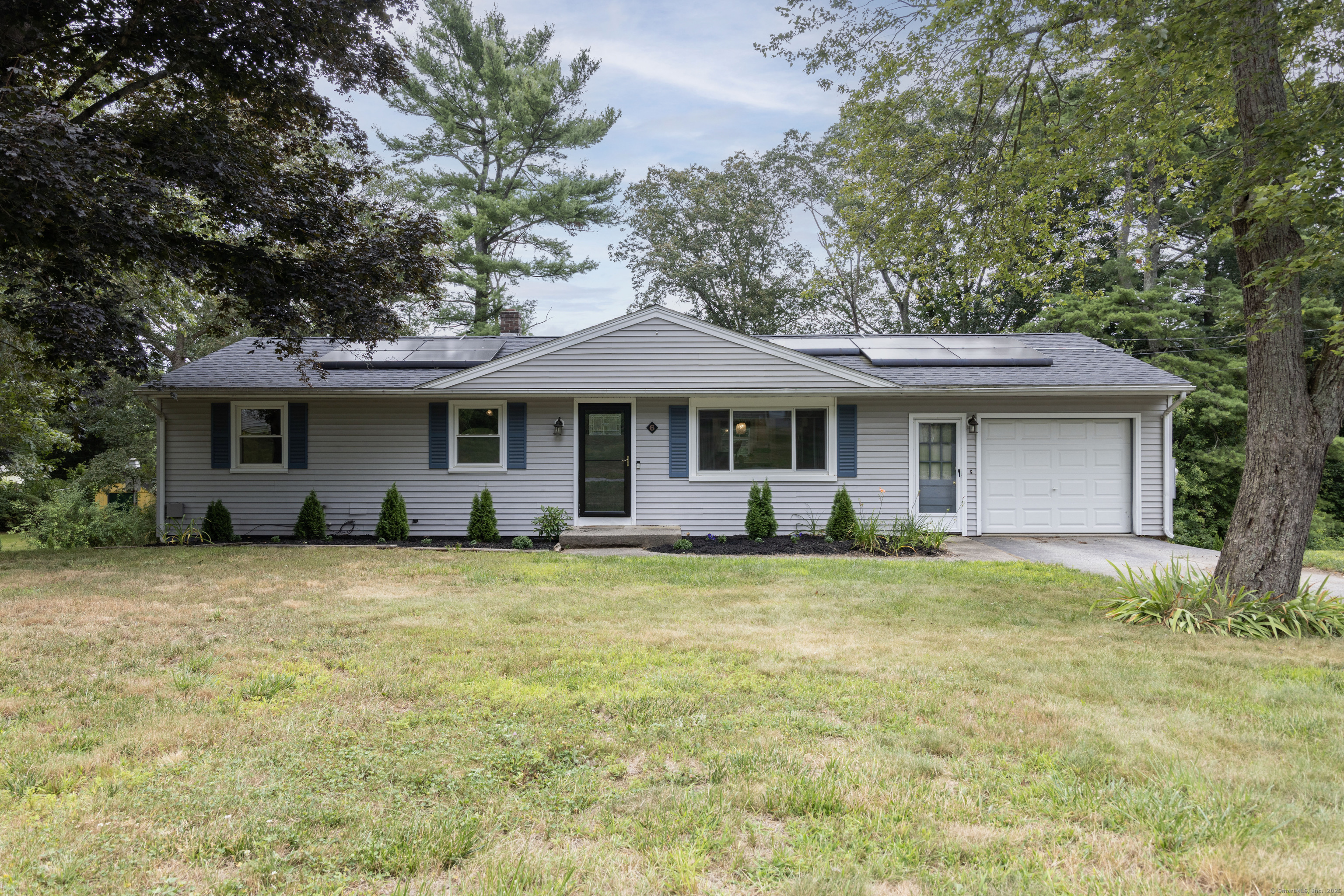 6 Oak Street Plainfield, CT 06374 - Photo 1 of 1 a front view of a house with a garden