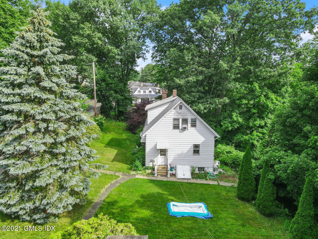 128 Halstead Avenue Greenwich, CT 06831 - Photo 2 of 11 a view of a house with backyard and sitting area