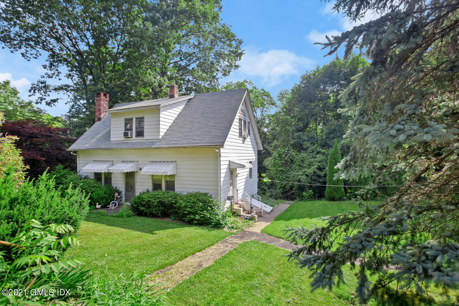128 Halstead Avenue Greenwich, CT 06831 - Photo 6 of 11 a front view of house with yard and green space
