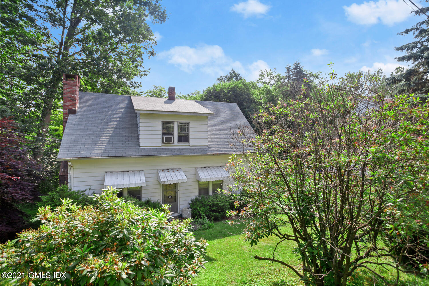 128 Halstead Avenue Greenwich, CT 06831 - Photo 7 of 11 a front view of a house with a yard