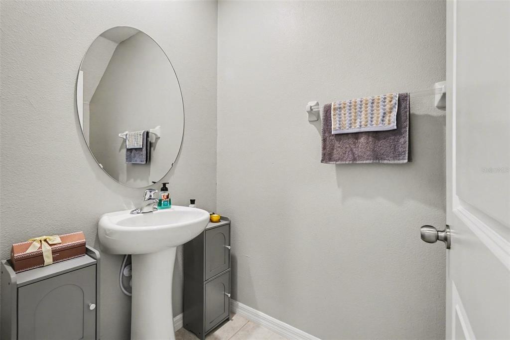 9424 Lemon Drop Loop Sun City Center, FL 33573 - Photo 12 of 31 a bathroom with a sink and mirror