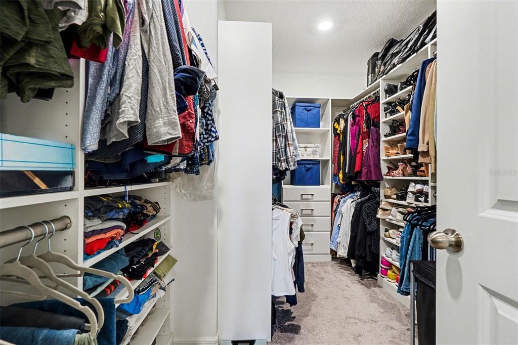9424 Lemon Drop Loop Sun City Center, FL 33573 - Photo 16 of 31 a view of walk in closet with clothes and shoes