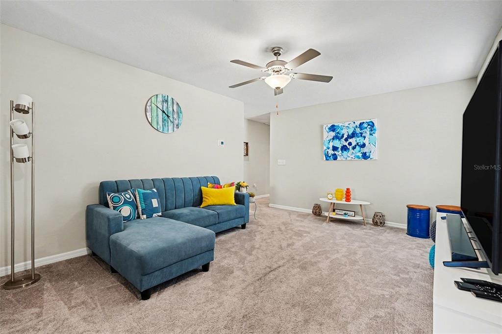 9424 Lemon Drop Loop Sun City Center, FL 33573 - Photo 18 of 31 a living room with furniture and a flat screen tv