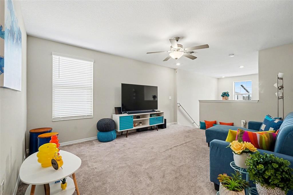 9424 Lemon Drop Loop Sun City Center, FL 33573 - Photo 20 of 31 a living room with furniture and a flat screen tv