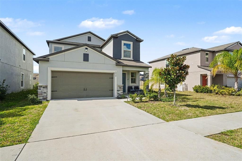 9424 Lemon Drop Loop Sun City Center, FL 33573 - Photo 2 of 31 a front view of a house with garden