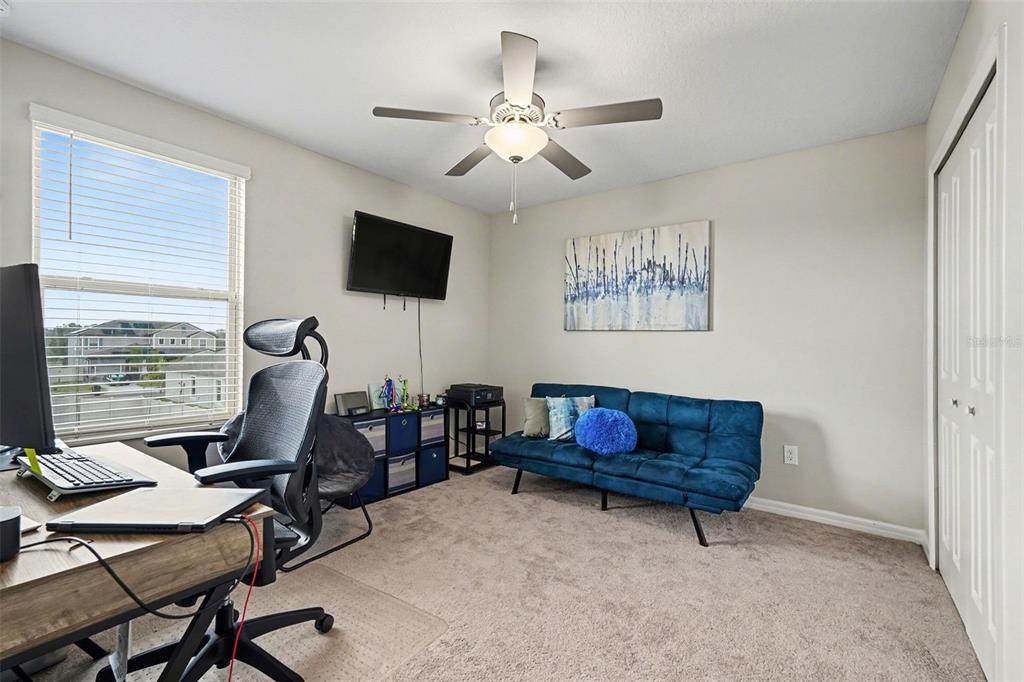 9424 Lemon Drop Loop Sun City Center, FL 33573 - Photo 28 of 31 a living room with furniture and a flat screen tv