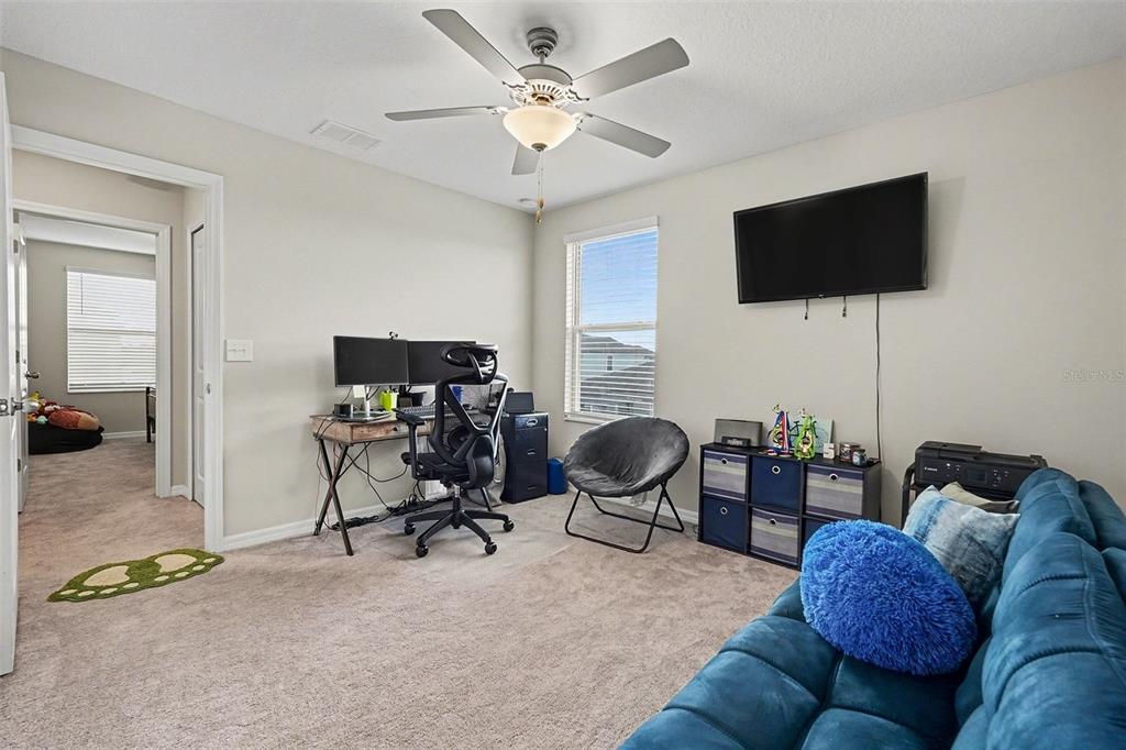 9424 Lemon Drop Loop Sun City Center, FL 33573 - Photo 29 of 31 a living room with furniture and a flat screen tv