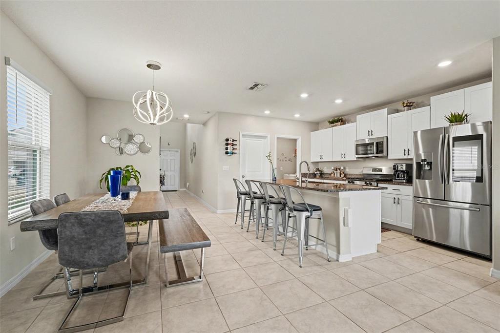 9424 Lemon Drop Loop Sun City Center, FL 33573 - Photo 9 of 31 a living room with stainless steel appliances furniture a dining table and kitchen view