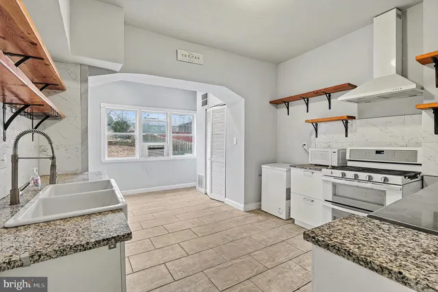 a view of a house with a yard covered with snow in the background