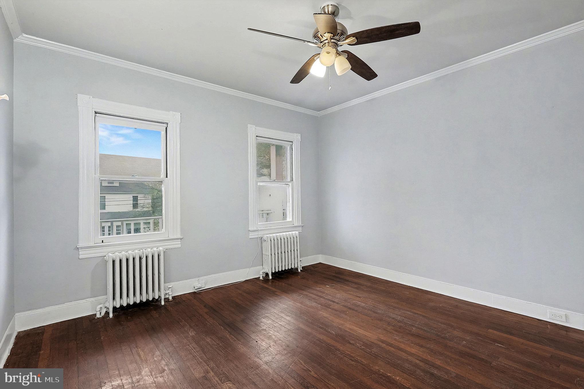 4014 33rd Street Mount Rainier, MD 20712 - Photo 8 of 37 a view of an empty room with wooden floor and a window