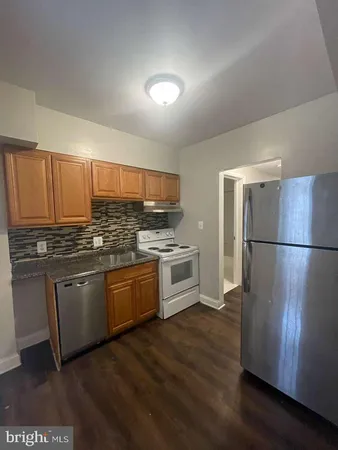 a kitchen with stainless steel appliances granite countertop a refrigerator sink and cabinets
