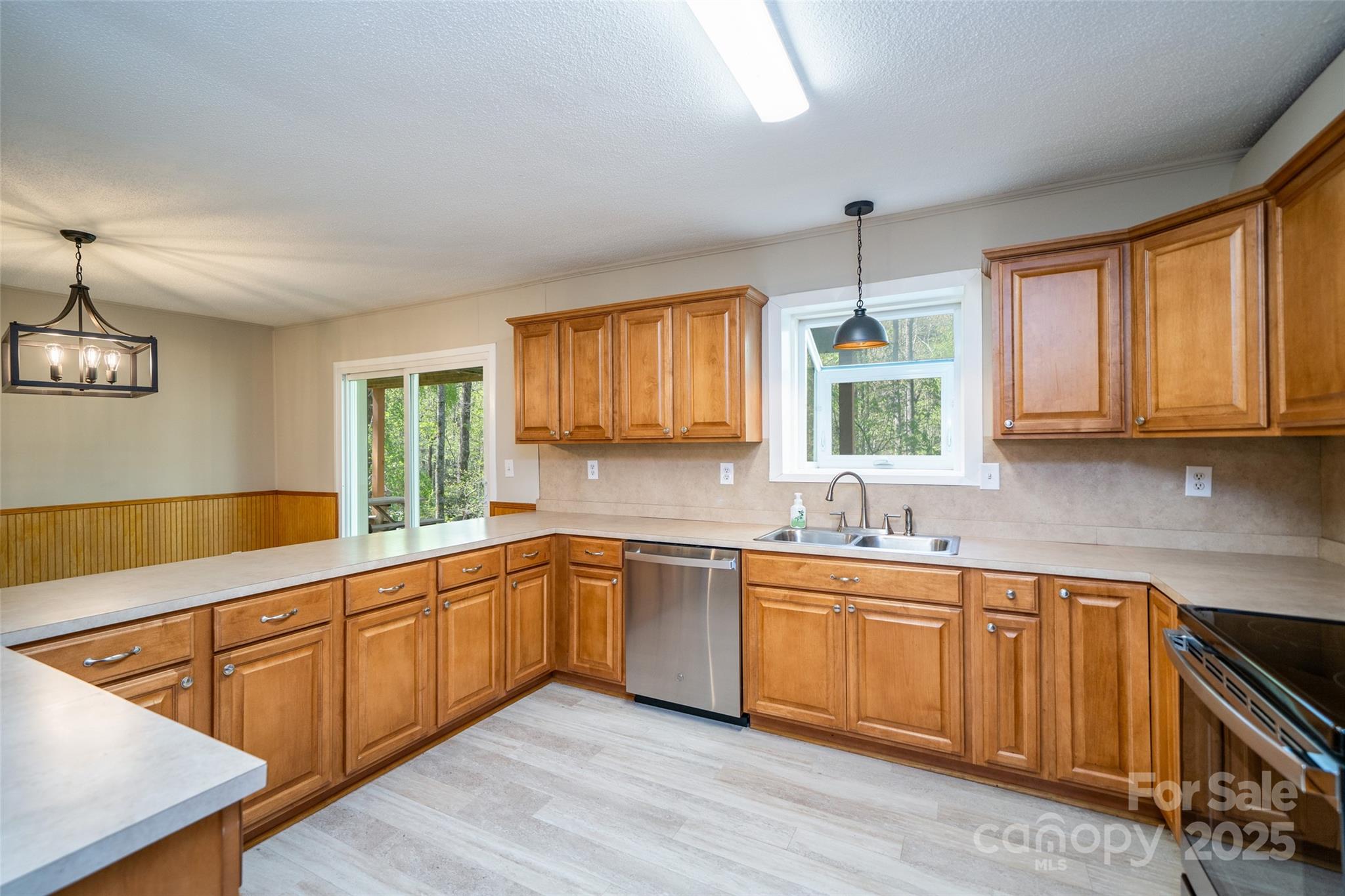 145 Jeter Mountain Road Hendersonville, NC 28739 - Photo 11 of 31 a kitchen with sink cabinets and window