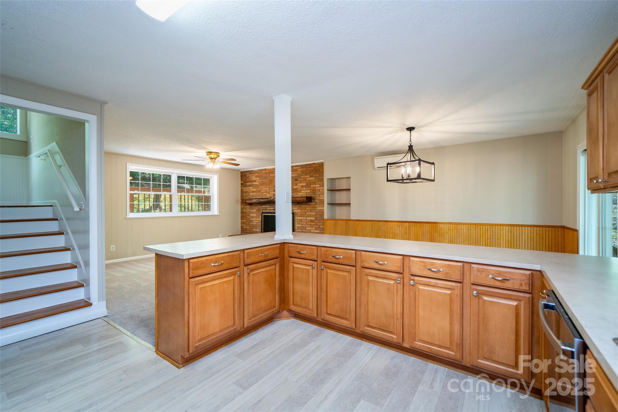 145 Jeter Mountain Road Hendersonville, NC 28739 - Photo 12 of 31 a kitchen with stainless steel appliances granite countertop a sink and a wooden floors