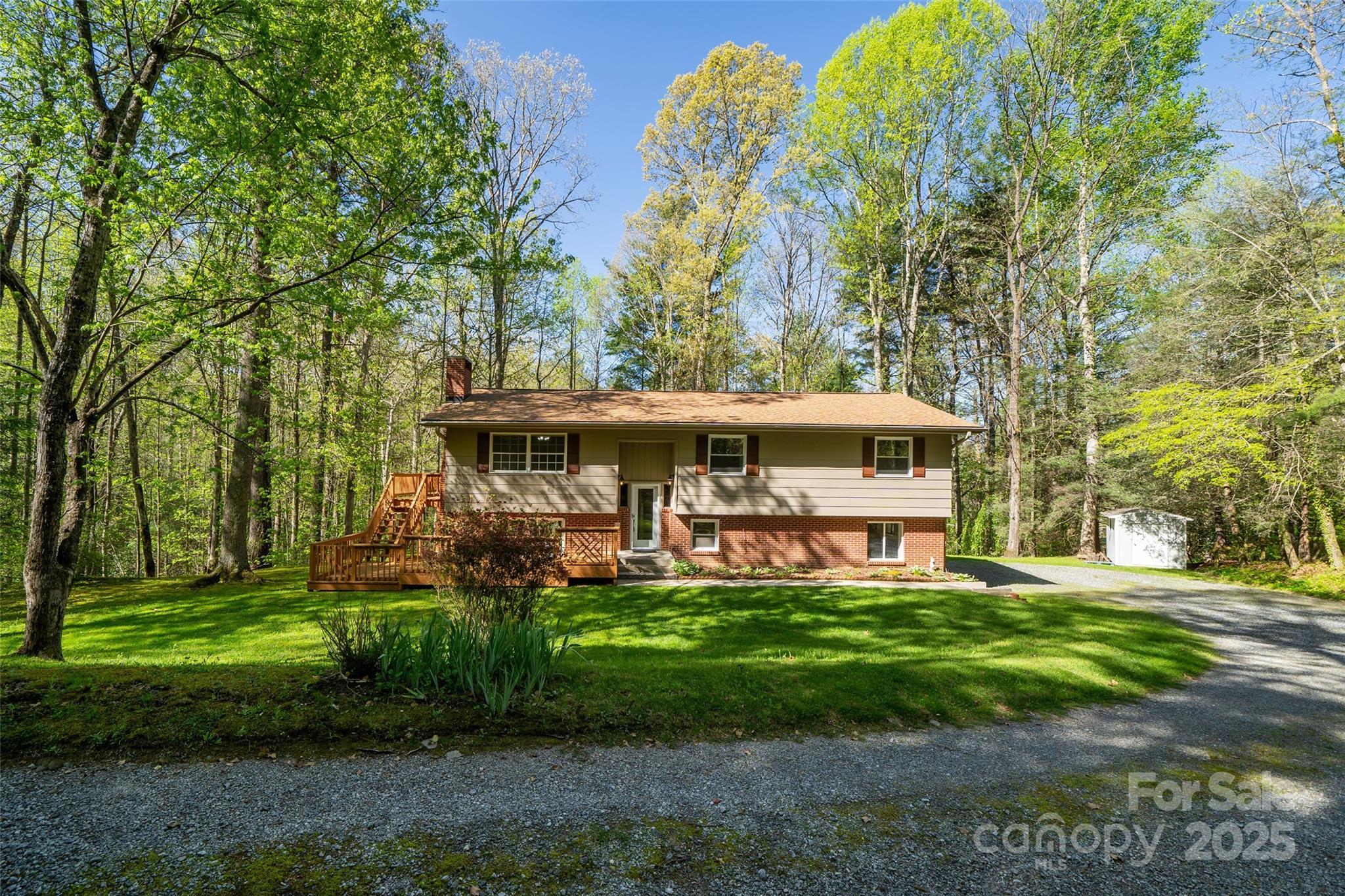 145 Jeter Mountain Road Hendersonville, NC 28739 - Photo 2 of 31 a front view of a house with garden