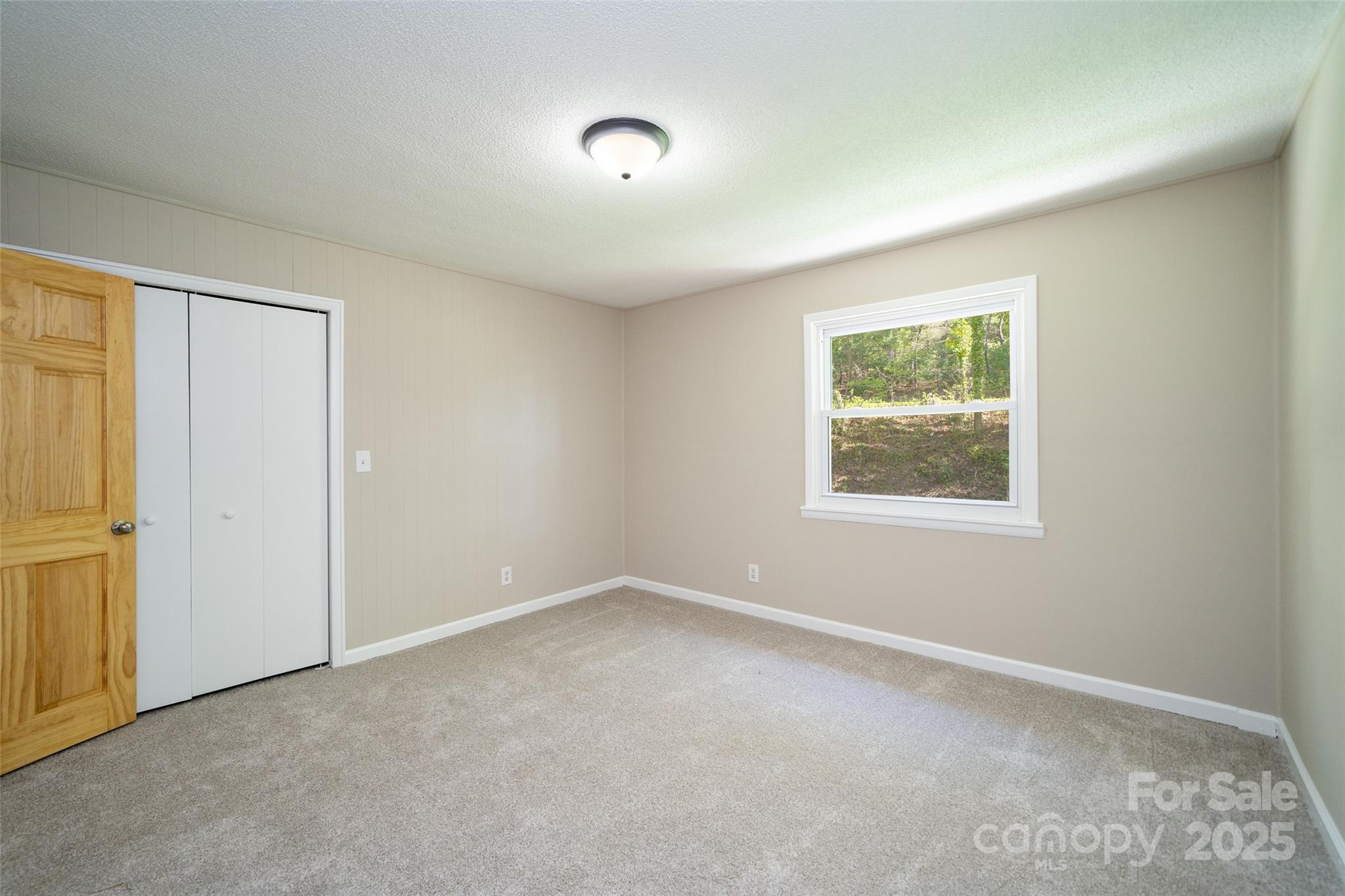 145 Jeter Mountain Road Hendersonville, NC 28739 - Photo 21 of 31 an empty room with windows