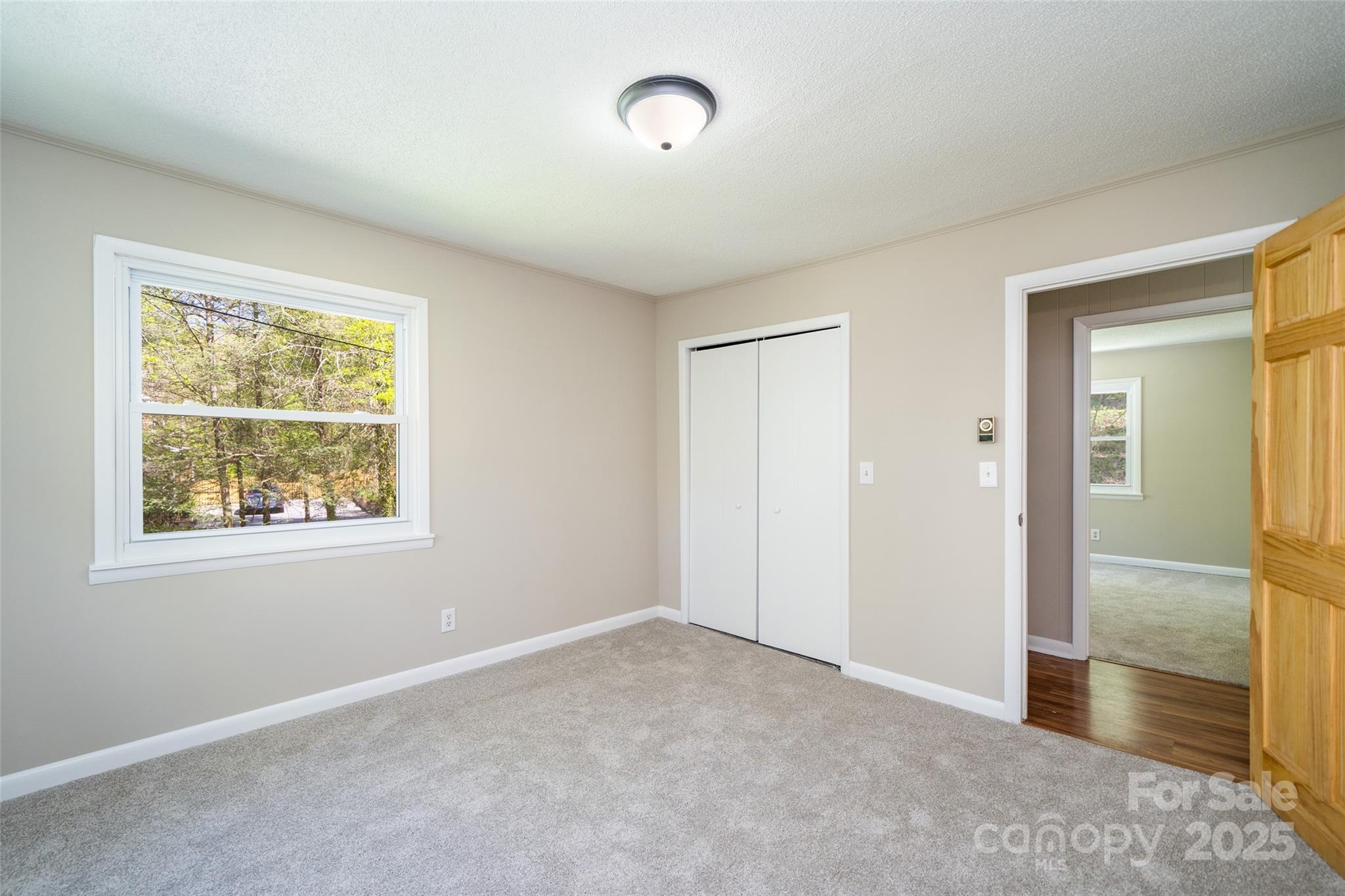 145 Jeter Mountain Road Hendersonville, NC 28739 - Photo 25 of 31 an empty room with windows and closet