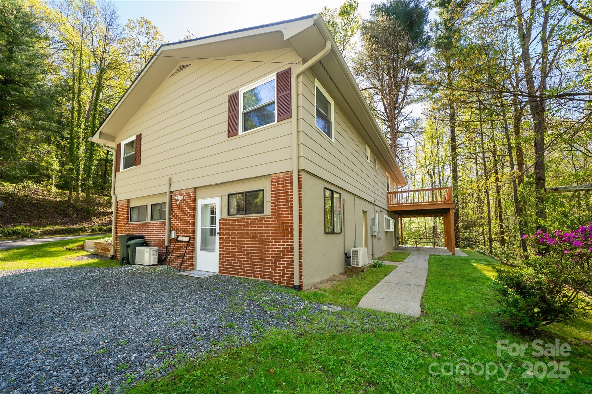 145 Jeter Mountain Road Hendersonville, NC 28739 - Photo 28 of 31 a view of a house with backyard and a tree
