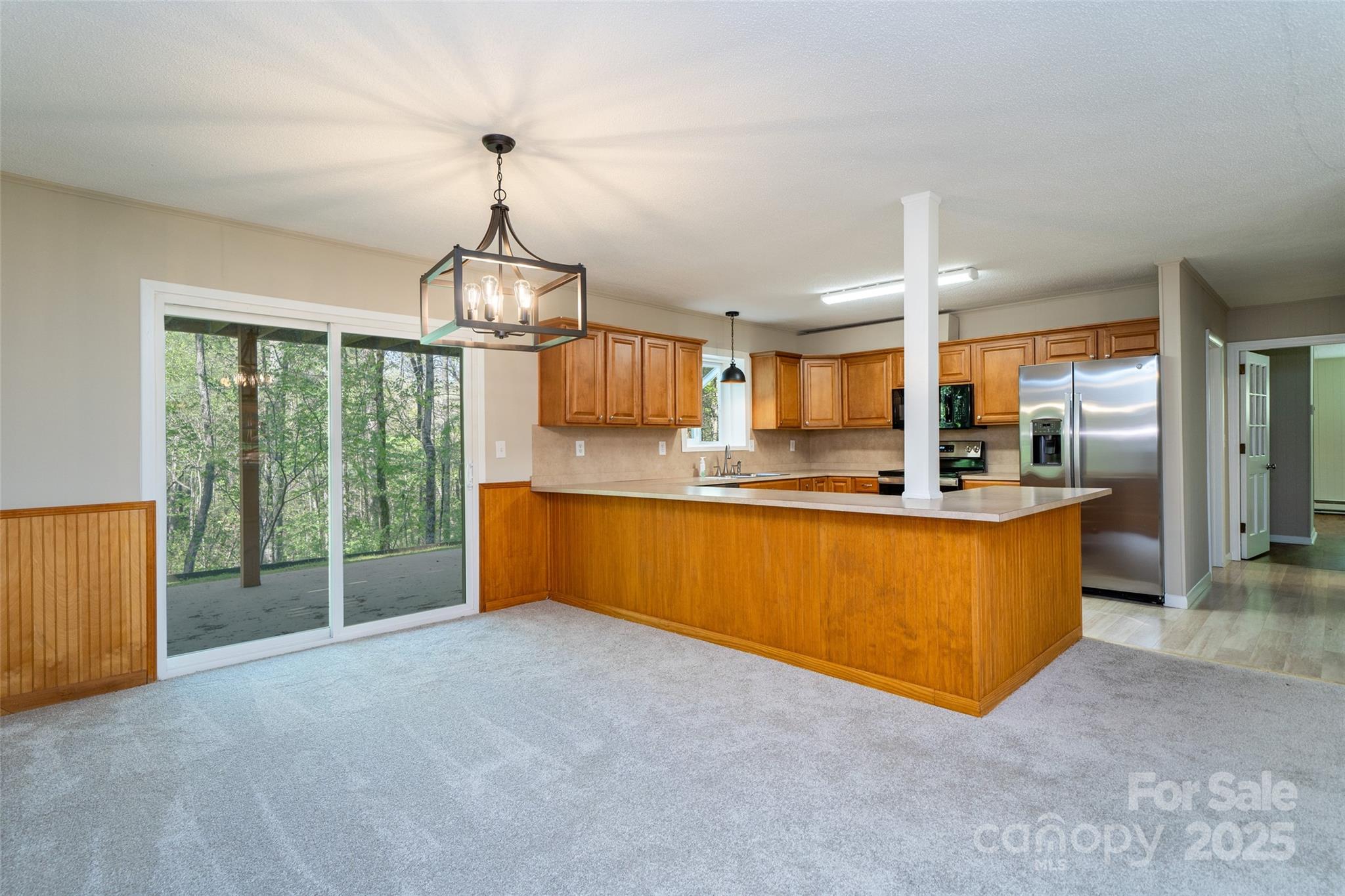 145 Jeter Mountain Road Hendersonville, NC 28739 - Photo 6 of 31 a large kitchen with stainless steel appliances granite countertop a sink and a large window