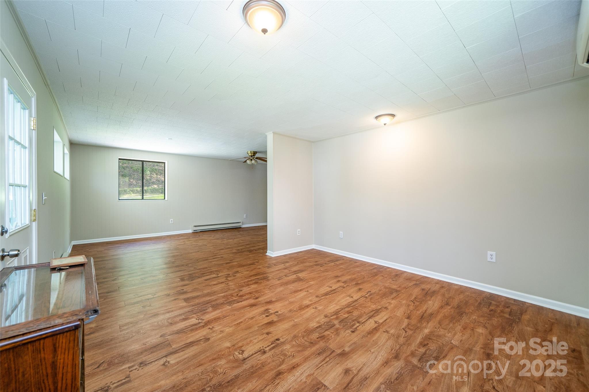 145 Jeter Mountain Road Hendersonville, NC 28739 - Photo 7 of 31 a view of an empty room with wooden floor and a window