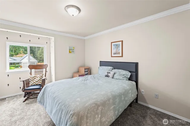 a bedroom with a bed a table and a window