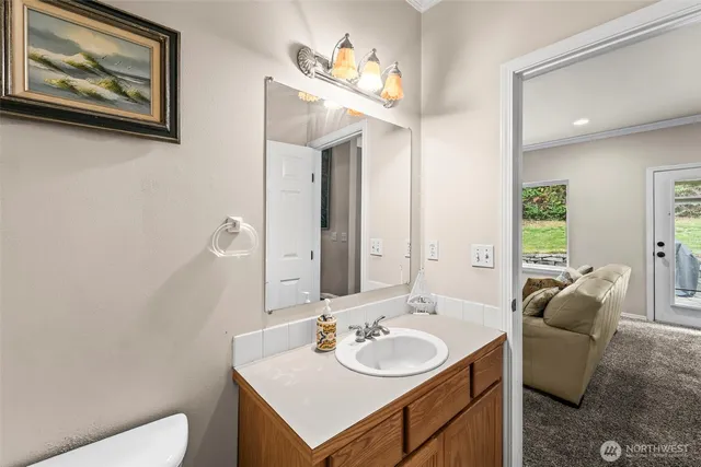 a bathroom with a toilet a sink and a mirror