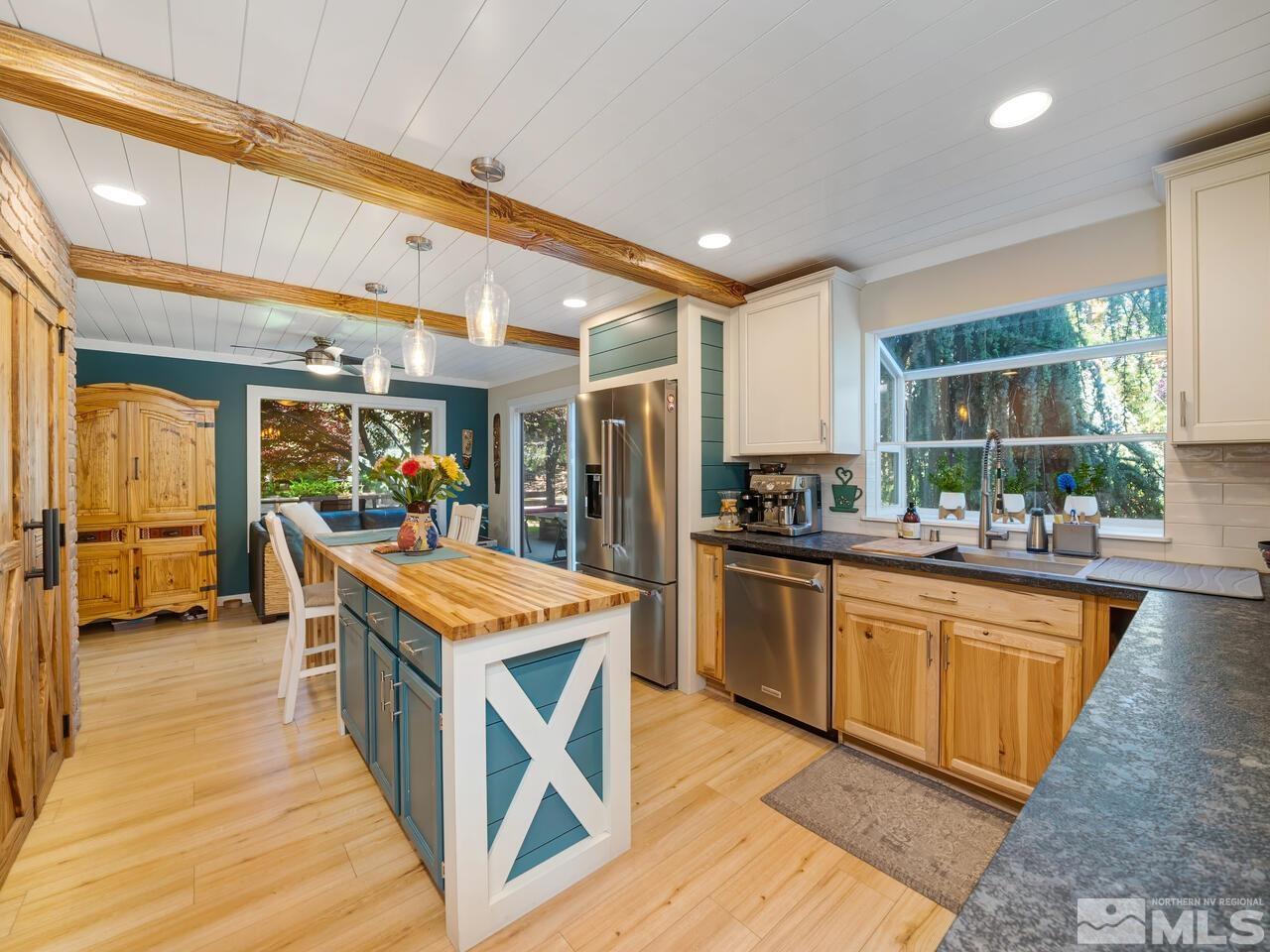 14555 Sundance Drive Reno, NV 89511 - Photo 11 of 40 a kitchen with stainless steel appliances granite countertop wooden cabinets and window