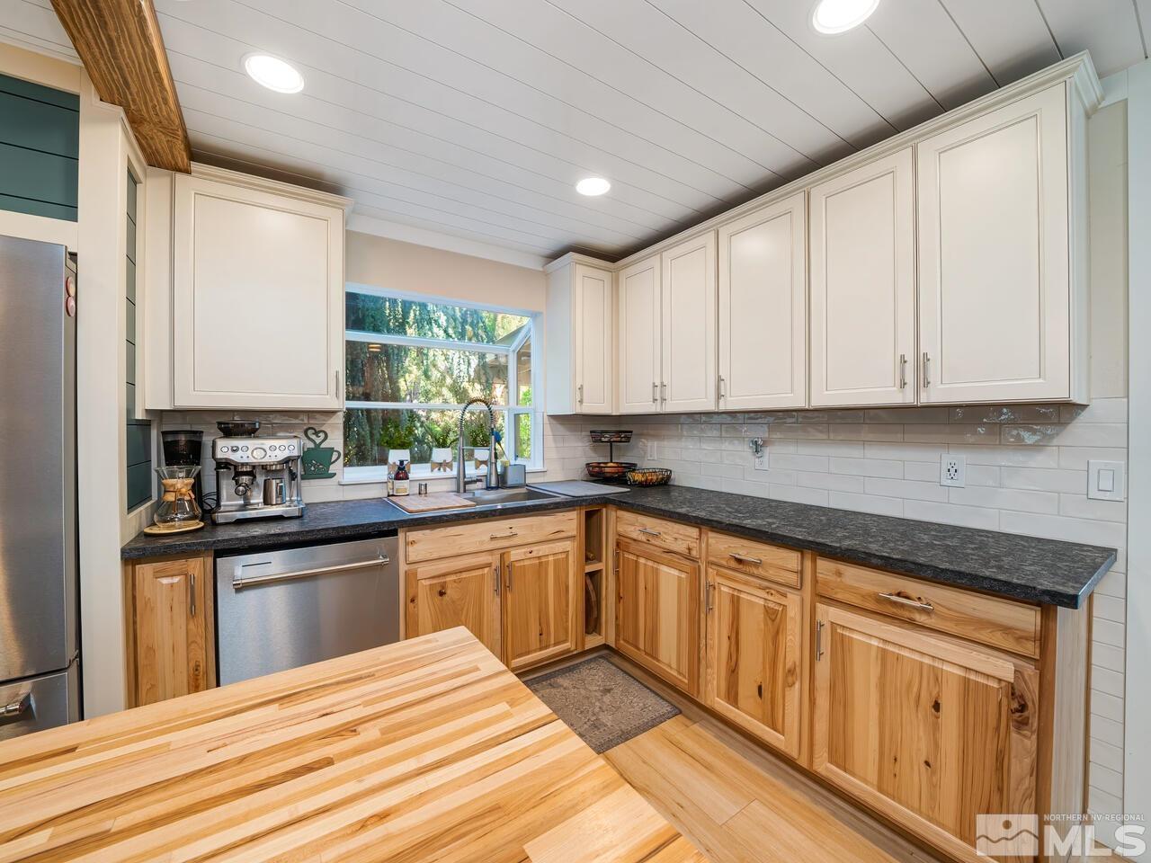 14555 Sundance Drive Reno, NV 89511 - Photo 12 of 40 a kitchen with stainless steel appliances granite countertop white cabinets granite counter tops and a window